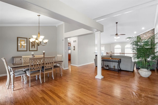 dining space featuring baseboards, ornamental molding, light wood-type flooring, ornate columns, and ceiling fan with notable chandelier