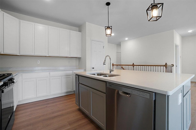 kitchen featuring sink, stainless steel dishwasher, an island with sink, and white cabinets