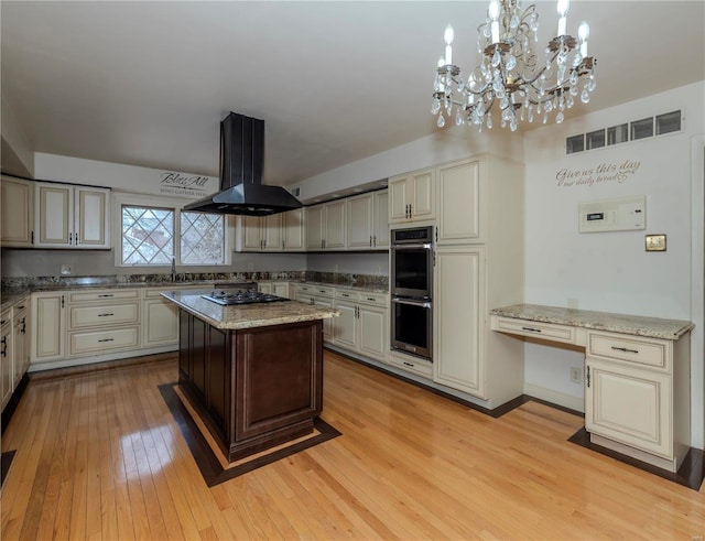 kitchen featuring visible vents, island exhaust hood, black electric cooktop, light wood-type flooring, and double oven