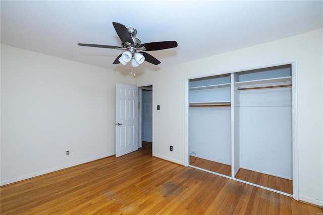 unfurnished bedroom with light wood-style floors, a closet, ceiling fan, and baseboards