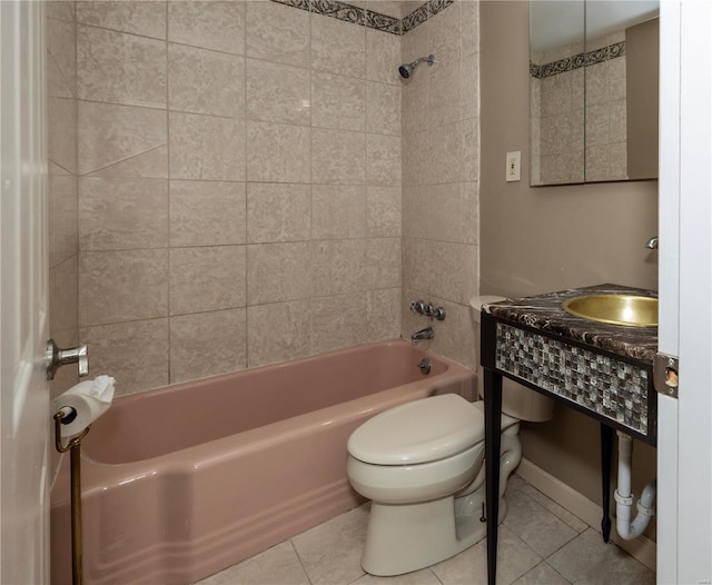 full bath with toilet, tile patterned flooring, shower / washtub combination, and a sink