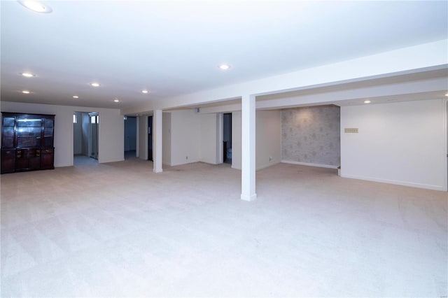 finished below grade area featuring recessed lighting, baseboards, and light colored carpet