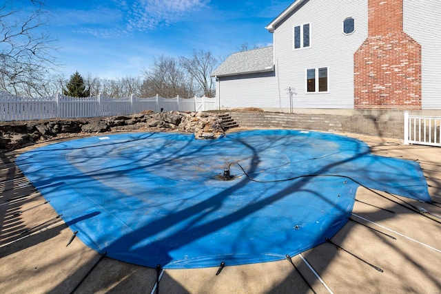 view of swimming pool featuring a fenced in pool and fence