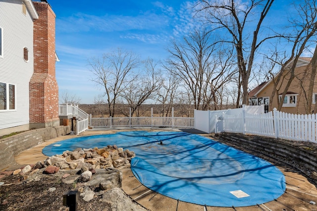 view of pool with a fenced in pool and fence