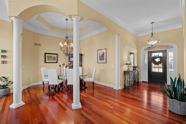 foyer entrance with baseboards, decorative columns, visible vents, and hardwood / wood-style floors