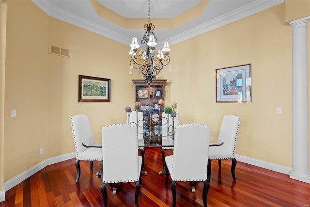 dining space featuring hardwood / wood-style floors, decorative columns, visible vents, and baseboards