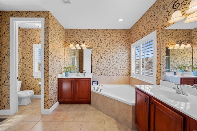 bathroom with wallpapered walls, tile patterned flooring, a garden tub, and a sink