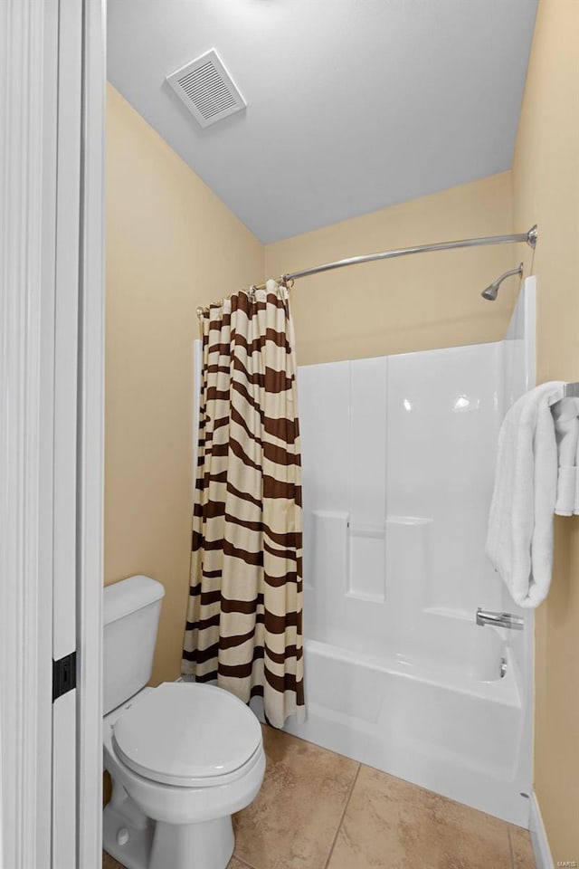 bathroom featuring toilet, shower / bath combination with curtain, tile patterned flooring, and visible vents