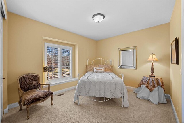 bedroom with carpet, visible vents, and baseboards