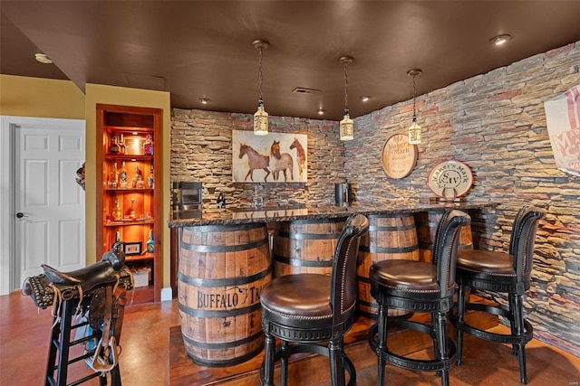 bar with a community bar, visible vents, and decorative light fixtures