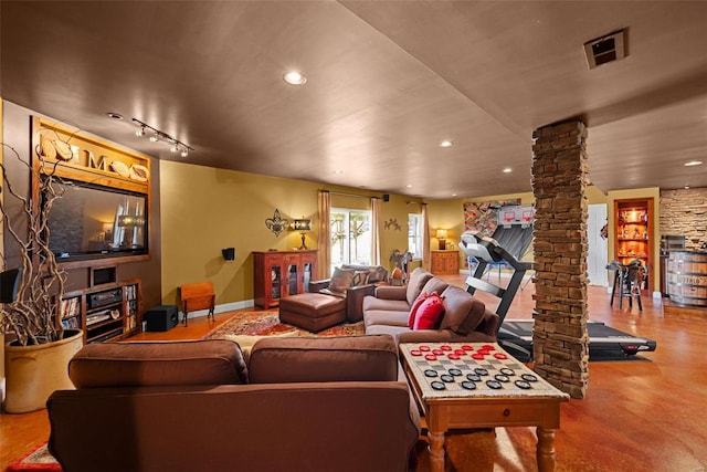 living room featuring track lighting, recessed lighting, visible vents, and ornate columns