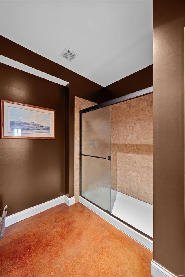 bathroom featuring visible vents, a shower stall, and baseboards