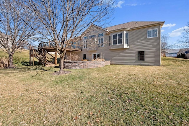 back of property featuring a yard, a wooden deck, and stairs