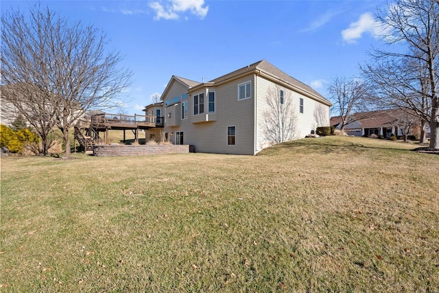 exterior space with a lawn, a wooden deck, and stairs