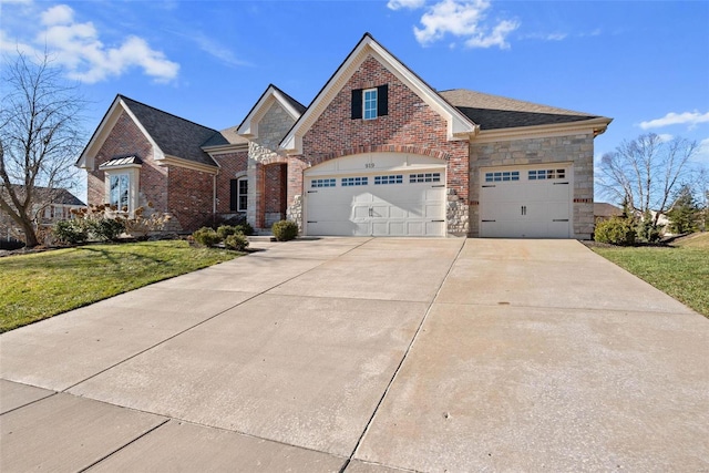 view of front of house featuring stone siding, brick siding, an attached garage, and a front yard