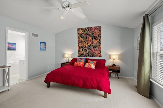 bedroom featuring visible vents, connected bathroom, carpet floors, baseboards, and vaulted ceiling