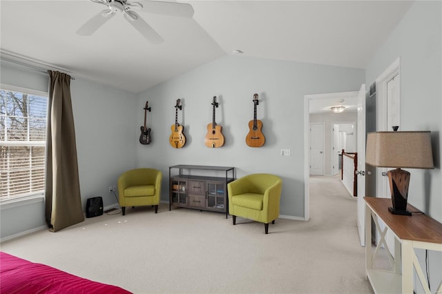 carpeted bedroom featuring baseboards, lofted ceiling, and a ceiling fan