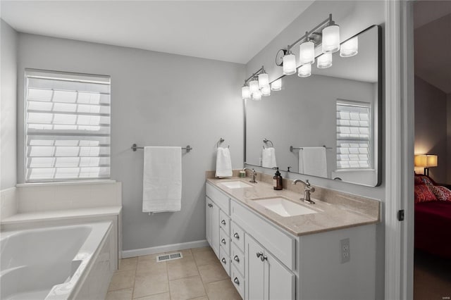 bathroom with a sink, visible vents, ensuite bathroom, and tile patterned flooring