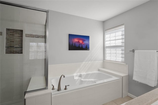 full bath with tile patterned floors, a garden tub, and a stall shower