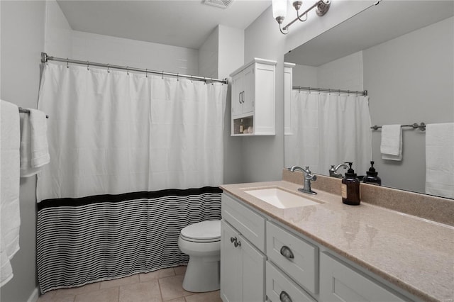 bathroom featuring visible vents, toilet, vanity, and tile patterned flooring