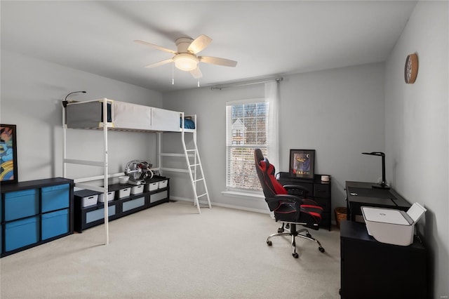 office space with baseboards, ceiling fan, and carpet floors