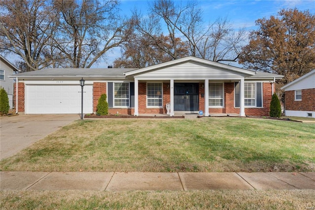 view of front of home with a garage, driveway, a front lawn, and brick siding