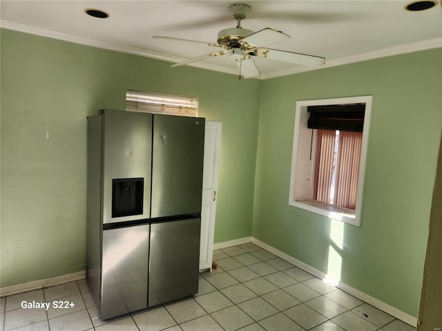 interior space featuring light tile patterned floors, ornamental molding, a ceiling fan, and baseboards