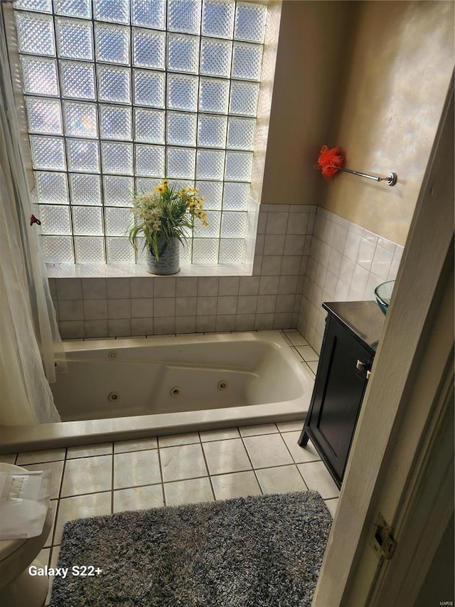 full bath with a whirlpool tub and vanity