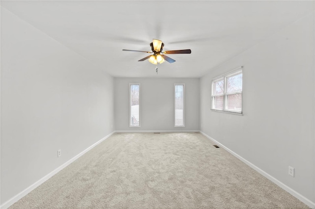 empty room featuring ceiling fan and carpet