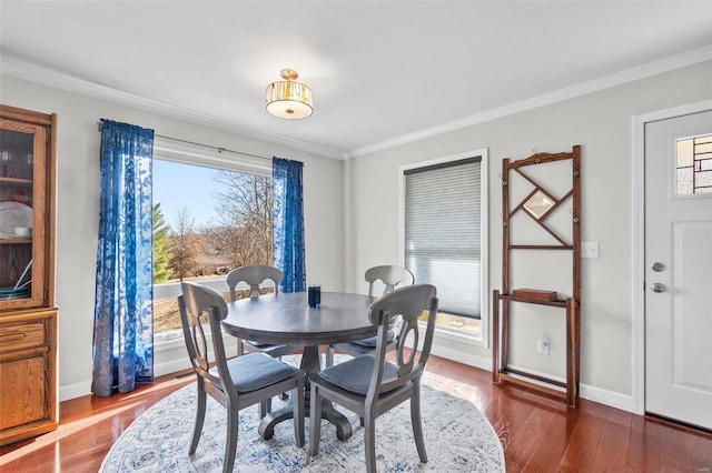 dining room with ornamental molding, plenty of natural light, and dark hardwood / wood-style flooring