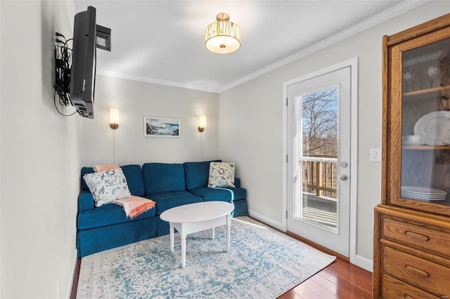 living room featuring dark wood-type flooring and ornamental molding