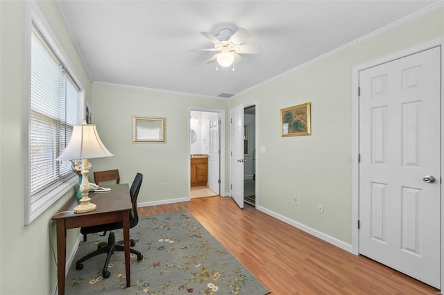 office space with crown molding, ceiling fan, and light hardwood / wood-style flooring