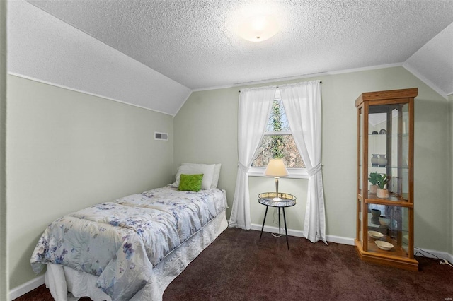 carpeted bedroom featuring vaulted ceiling and a textured ceiling