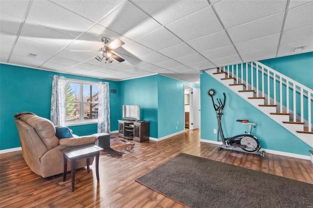 interior space featuring ceiling fan, hardwood / wood-style floors, and a drop ceiling