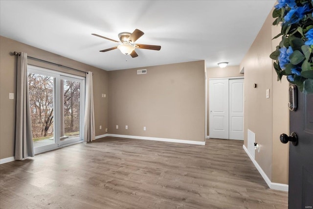 unfurnished room featuring hardwood / wood-style flooring and ceiling fan