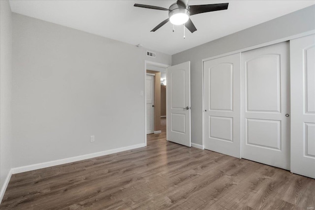 unfurnished bedroom featuring ceiling fan, a closet, and light hardwood / wood-style flooring