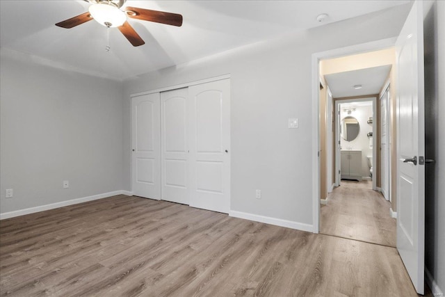 unfurnished bedroom featuring a closet, ceiling fan, and light hardwood / wood-style flooring