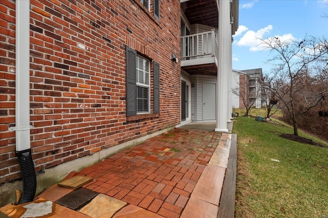 view of exterior entry featuring a yard