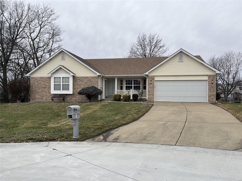 ranch-style house with a garage, a front yard, and a porch