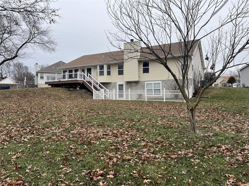 back of property with a wooden deck