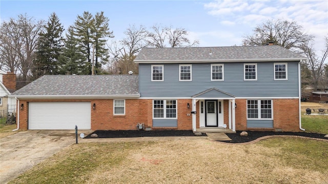 view of front of house with a garage and a front lawn