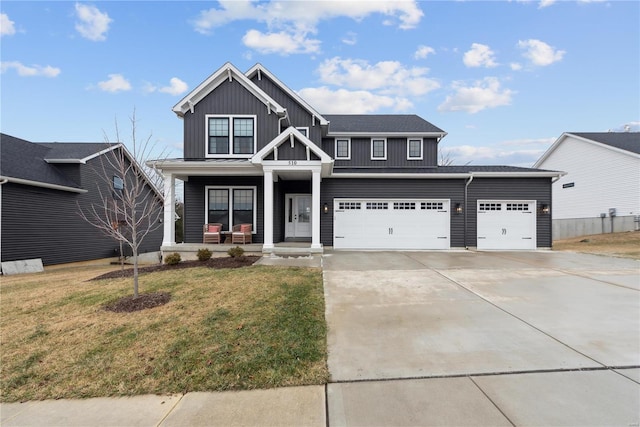 view of front of property with a porch, a garage, and a front yard