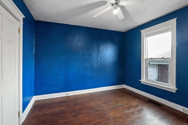 unfurnished room featuring dark hardwood / wood-style flooring and ceiling fan