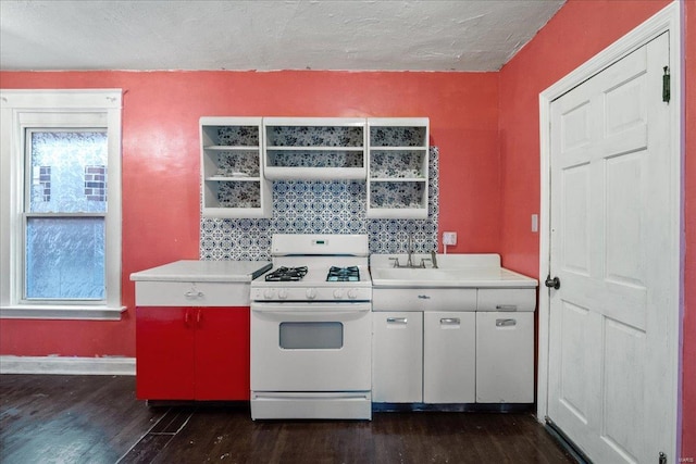 kitchen with dark wood-type flooring, decorative backsplash, white range with gas stovetop, and a textured ceiling