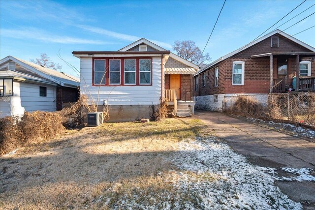 bungalow-style house featuring central AC unit