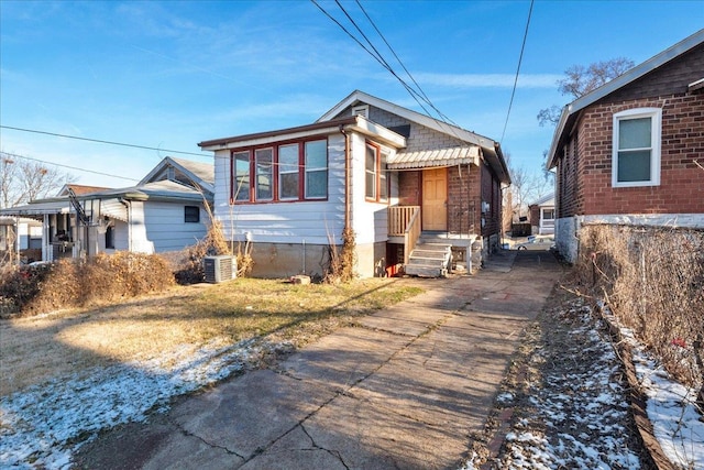 bungalow-style home with central AC unit