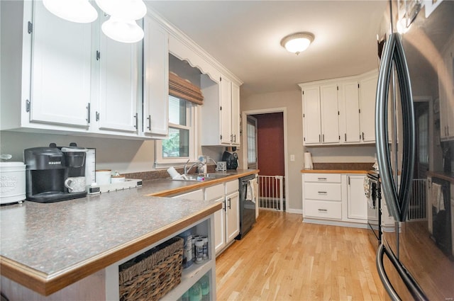 kitchen with stainless steel refrigerator, dishwasher, and white cabinets