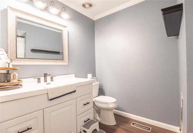 bathroom featuring crown molding, wood-type flooring, vanity, and toilet