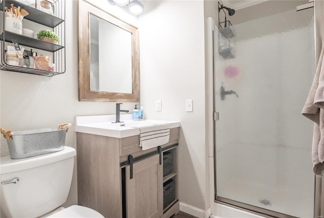 bathroom with walk in shower, vanity, and toilet