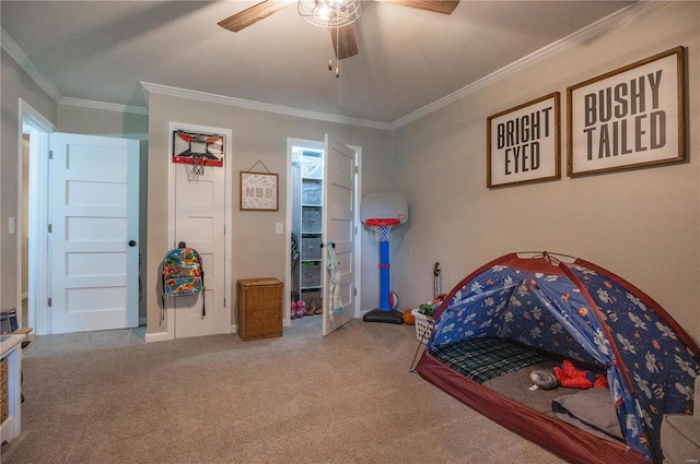 bedroom featuring carpet floors, ornamental molding, and ceiling fan